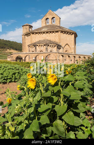Sunflowers in front of Church of Saint Mary of Eunate (Iglesia de Santa María de Eunate), Muruzábal, Navarra, Spain Stock Photo