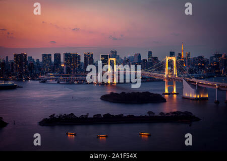 Tokyo skyline with Tokyo Tower and Rainbow Bridge at night in Japan