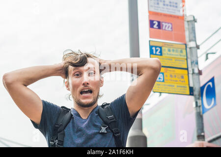 A man lost in Hong Kong. Buses in hong kong. Stock Photo