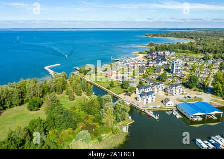 View over marina of village Rechlin towards lake Mueritz,holiday cottages, pleasure boats, Rechlin, Mecklenburg-Vorpommern, Germany Stock Photo