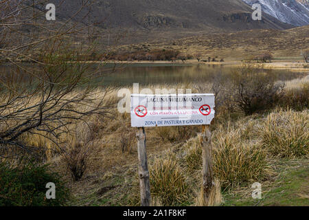 Main entrance sign to the area saying 'Laguna Willimanco, forbidden enter with dogs, cattle and pasture zone' Stock Photo