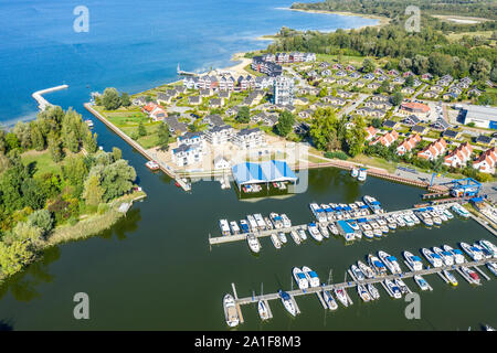 View over marina of village Rechlin towards lake Mueritz,holiday cottages, pleasure boats, Rechlin, Mecklenburg-Vorpommern, Germany Stock Photo
