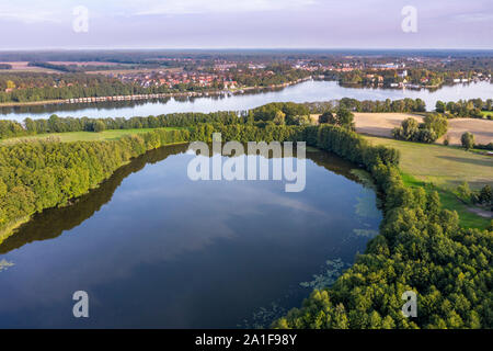 Drone shot, aerial view over  lake Schulzensee to lake Mirow, castle Mirow on island back right, Mecklenburg lake district, Mecklenburg-Vorpommern, Ge Stock Photo