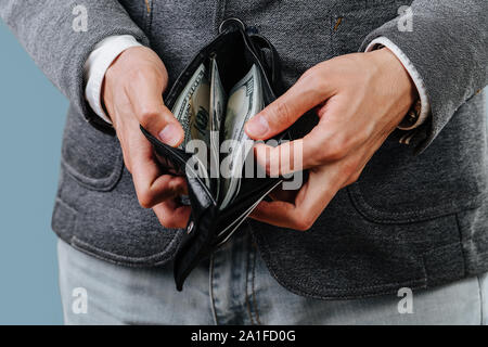 Businessman in a suit is counting cash in his wallet. Close up Stock Photo