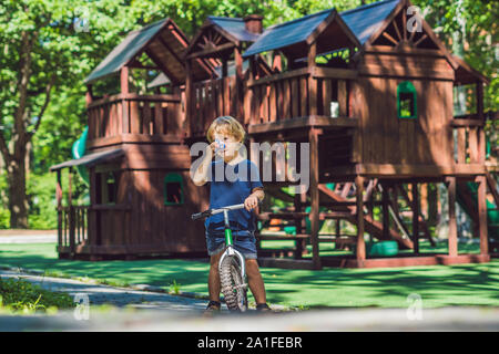 Boy playing with fidget spinner. Child spinning spinner on the playground. Blurred background. Stock Photo