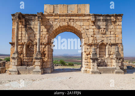 The Triumphal Arch devoted to Emperor Caracalla at the 3rd Century Ruins at Volubilis morocco Stock Photo