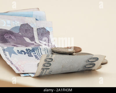 Turkish liras on bills and coins with background cream Stock Photo