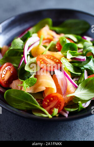 Salmon Salad with spinach, cherry tomatoes, corn salad, baby spinach, fresh mint and basil. Home made food. Concept for a tasty and healthy meal Stock Photo