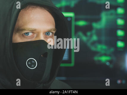Hacker in black mask. Hacking and internet security concept. Stock Photo