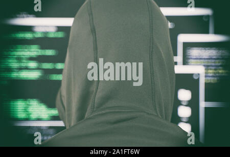 Hacker in black hoodie. Hacking and internet security concept. Stock Photo
