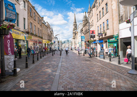 People strolling along the pedestrianized High Street in Inveness city centre on a sunny day Stock Photo