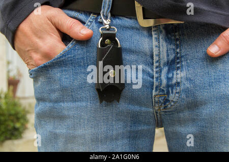 Leather keychain in Bat shape and old key in wooden door. - image Stock Photo