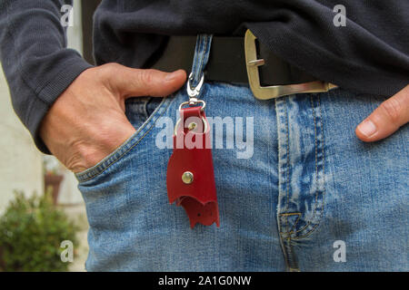 Leather keychain in Bat shape and old key in wooden door. - image Stock Photo