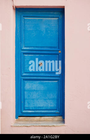 Close-up of an old blue door or a rose colored home Stock Photo