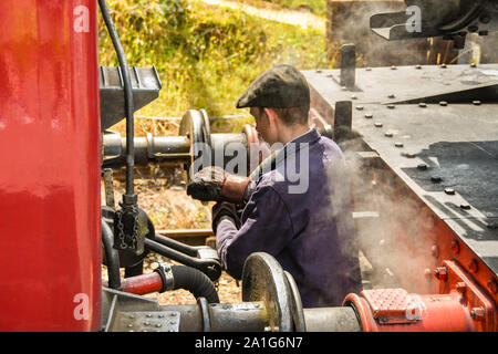 CRANMORE, ENGLAND - JULY 2019: Steam train worker coupling a steam engine to a carriage at Cranmore Station on the East Somerset Railway. Stock Photo