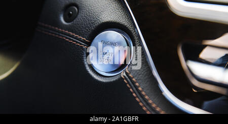 start-stop button engine on a leather base of a business car with shallow depth of field Stock Photo