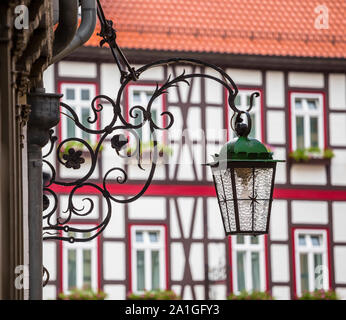 Street lamp on a beautiful decorative holder against the backdrop of half-timbered buildings Stock Photo
