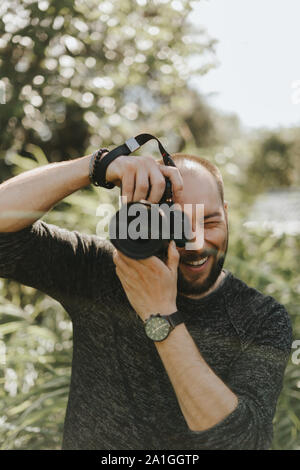 Happy photographer is taking a photo Stock Photo