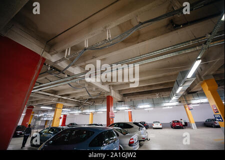 Paris, France - Jul 14, 2011: Wide angle view of French underground parking in central Paris with side view of multiple French and German cars parked in a row Stock Photo