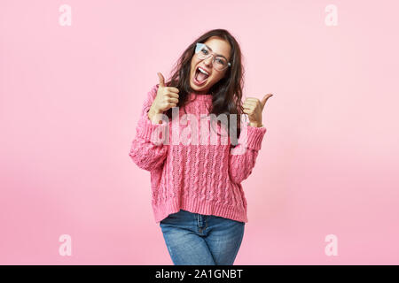 Happy excited woman smile holding thumbs up gesture, beautiful young woman smile looking at camera Stock Photo