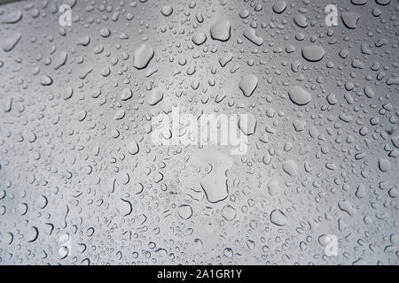 Water droplets stick on the glass surface. Stock Photo