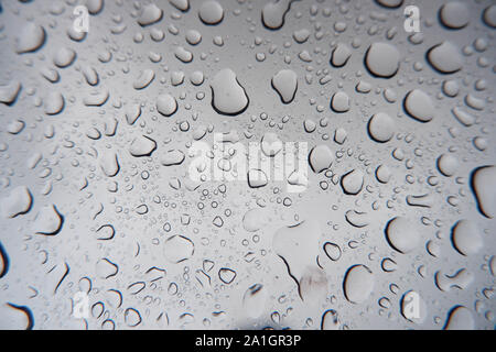 Water droplets stick on the glass surface. Stock Photo