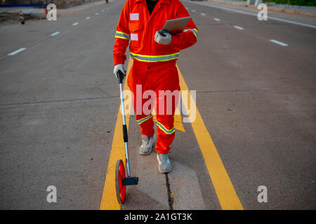 Civil work, measure the road with wheels, measure Stock Photo