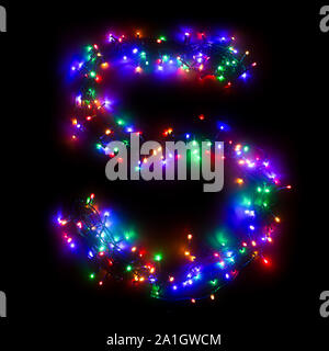 Arabic numeral "5" from a multi-colored electric garland on a black isolated background. New year numbers. A wreath of colored light bulbs. Congratula Stock Photo
