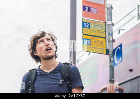 A man lost in Hong Kong. Buses in hong kong. Stock Photo