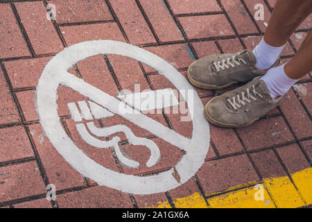 You can not smoke in Hong Kong. Sign on the sidewalk. Stock Photo