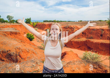 Young woman in red canyon near Mui Ne, southern Vietnam. Stock Photo