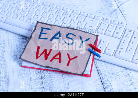 Text sign showing Easy Way. Business photo text making hard decision between two less and more effort method notebook paper reminder clothespin pinned Stock Photo