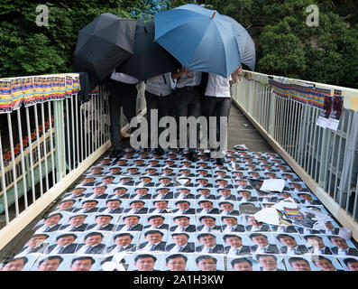 Wanchai, Hong Kong. 26 September, 2019. Human chain formed by students from local secondary schools in Hong Kong to support the pro democracy movement and anti-extradition bill. Local school students march over photos Julius Ho stuck to footbridge. Stock Photo