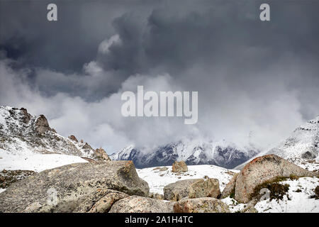 High mountains with snow at overcast dark sky in Tian Shan, Kazakhstan Stock Photo