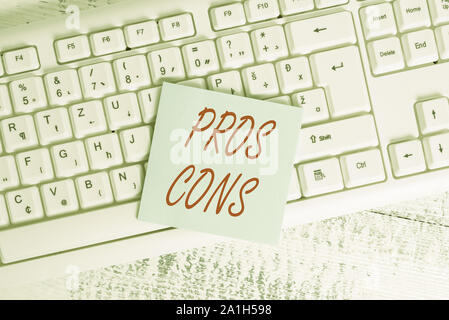 Conceptual hand writing showing Pros Cons. Concept meaning The favorable and unfavorable factors or reasons of demonstrating Keyboard office supplies Stock Photo