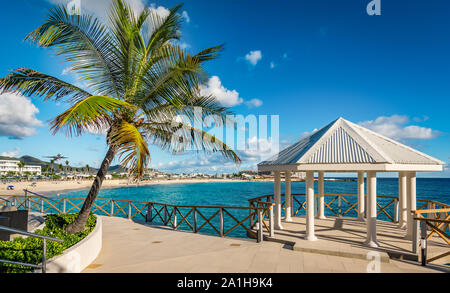 Romantic pavilion and palm tree on St Maarten Island. Maho bay beach background. Stock Photo