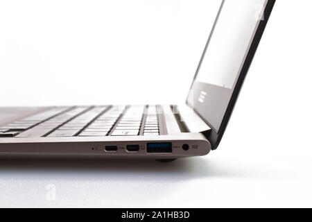 a modern metal laptop with opened lid on white background for abstract background Stock Photo