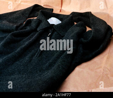 a black sweater laying  on brown wrapping paper Stock Photo