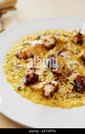 Fregola pasta cooked in risotto style with grilled octopus Stock Photo