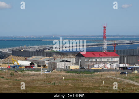 Taman, Russia. 26th July, 2019. From the Russian mainland: The Crimean bridge between Kerch on the Crimean peninsula and the Russian heartland, built under protest of Ukraine and the international community. In addition to the motorway, tracks will also be laid on a parallel bridge. The train service is scheduled to start at the end of the year. Sanctions and high prices, but also major projects and hope: five years after the annexation of the Crimea, Russia is expanding its power on the Black Sea peninsula. (to dpa-story: 'Russian' life in Crimea) Credit: Ulf Mauder/dpa/Alamy Live News Stock Photo