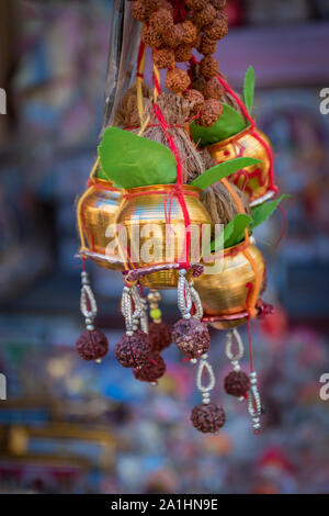 Copper Kalash with rudraksha mala, coconut, mango leaf, Red Thread (Kalava) decoration essential in Hindu puja. selective focus Stock Photo