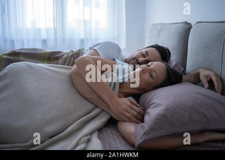 Young couple is lying in bed and sleeping. Stock Photo