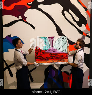 London Sotheby's, London, UK. 27 Sept 2019 - Technicians hold Andy Warhols's artwork titled 'Vesuvius' - Est - £280,000 - £350-000 in front of Kaws' artwork titled 'The Final Machine' Est - £5000,000 - £700,000 during the preview of SothebyÕs Frieze Week Contemporary Art Sale. The auction will take place on 3rd October 2019.   Credit: Dinendra Haria/Alamy Live News Stock Photo