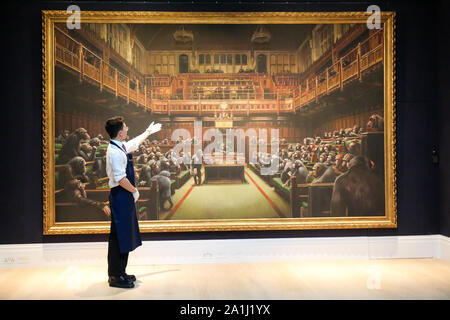 London Sotheby's, London, UK. 27 Sept 2019 - A technician points at ÔBanksyÕs artwork titled 'Dystopian View of The House of Commons Comes to London' Est -£1.5 C £2 million during the preview of SothebyÕs Frieze Week Contemporary Art Sale. The auction will take place on 3rd October 2019.   Credit: Dinendra Haria/Alamy Live News Stock Photo