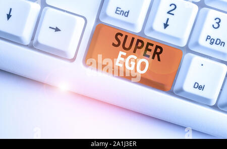 Writing note showing Super Ego. Business concept for The I or self of any demonstrating that is empowering his whole soul White pc keyboard with note Stock Photo