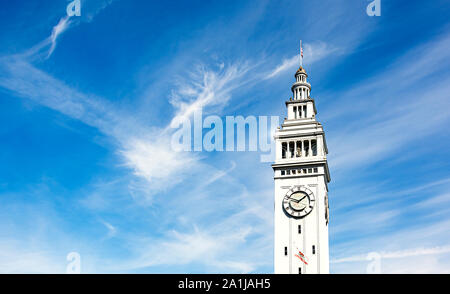 The clock tower of the Ferry Building in San Francisco on a clear day with light clouds Stock Photo