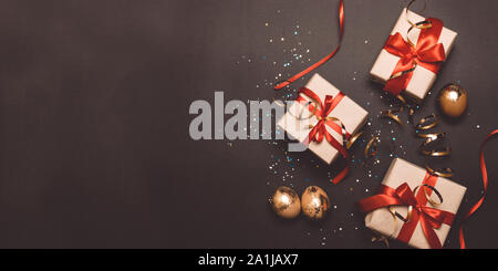 Easter flat lay and wrapped gift boxes, decorative gold eggs. Holiday banner for website. Flat lay style composition, top view. Stock Photo