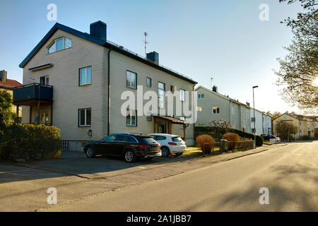 Car parked on a side of the street in quiet rural area of residential suburbs. Stock Photo