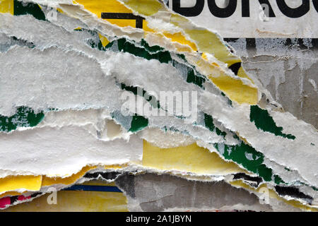 closeup details of Torn and weathered advertising poster layers Stock Photo