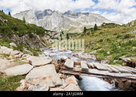 Bridge over mountain creek in Austrian/Italian Alps. Stock Photo